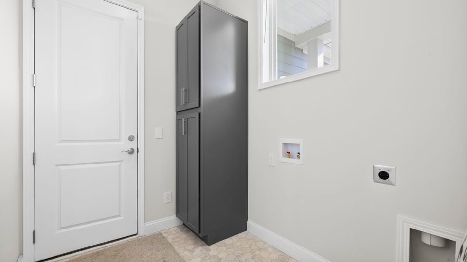 Walk in laundry room with storage.