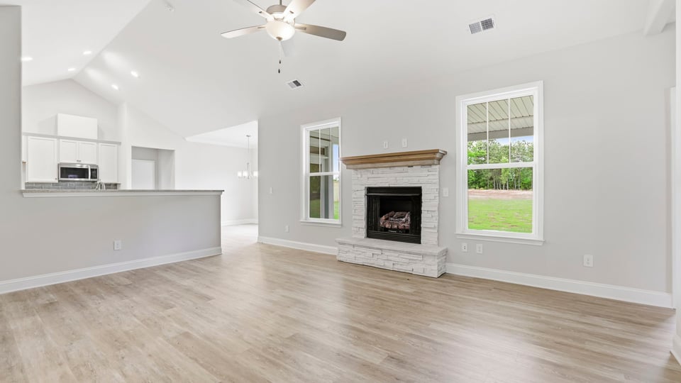 Family room with fireplace and windows.