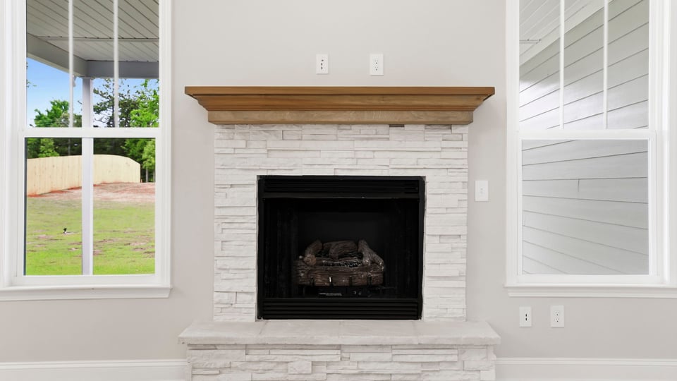 Family room with fireplace and windows.