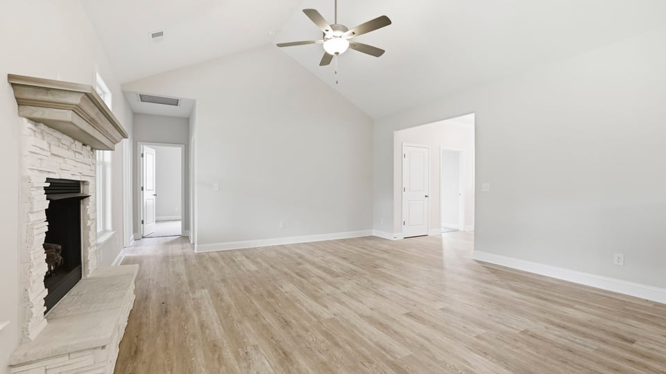 Family room with fireplace and windows.