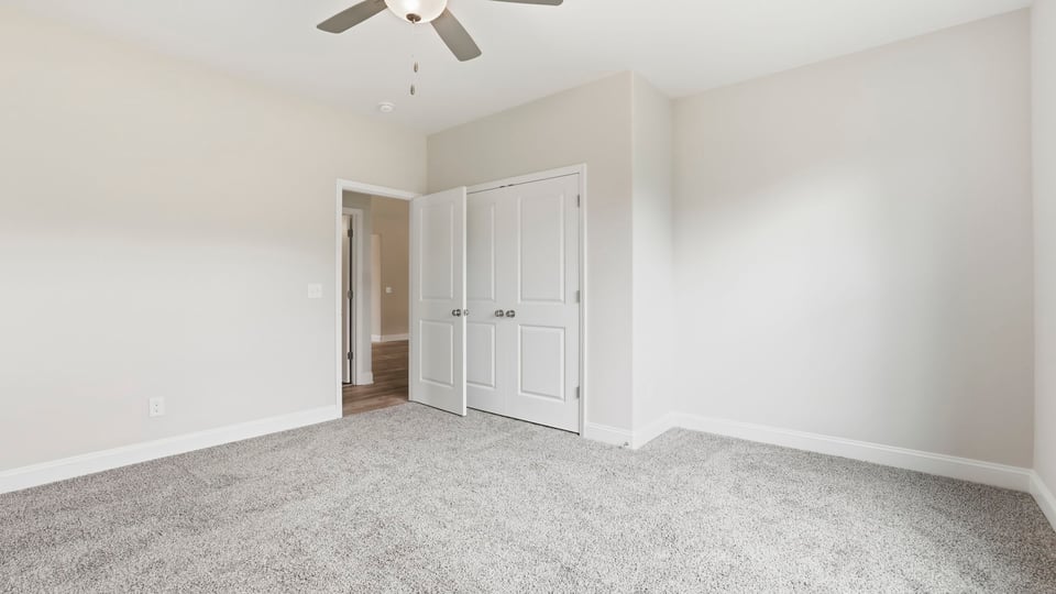 Bedroom with carpet and window.
