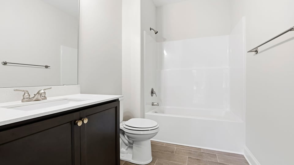 Bathroom with single vanity sink and bathtub.
