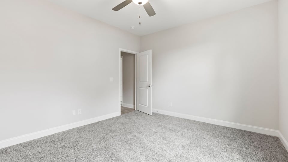 Bedroom with carpet and window.