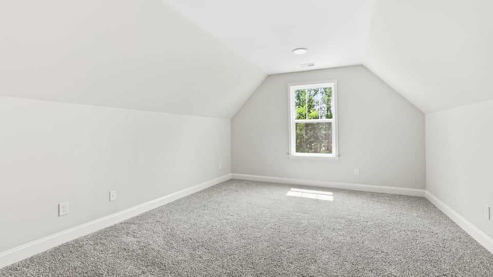 Bedroom with carpet and window.