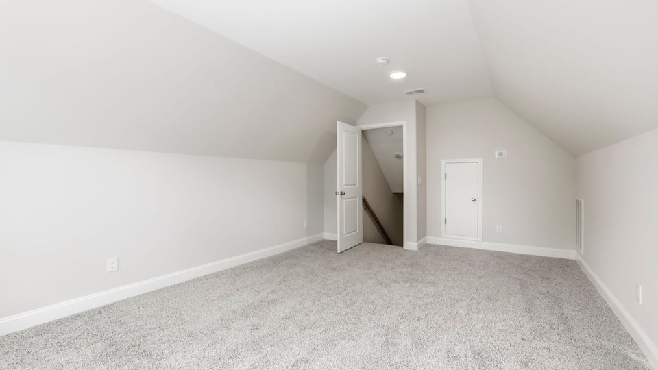 Bedroom with carpet and window.