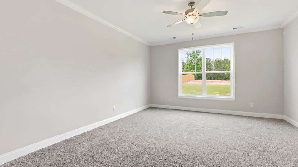Bedroom with carpet and window.