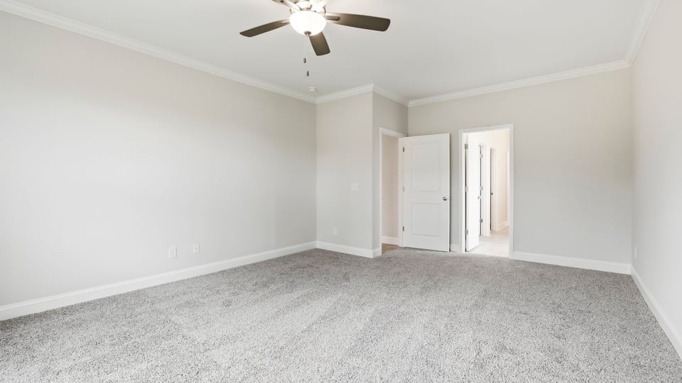 Bedroom with carpet and window.