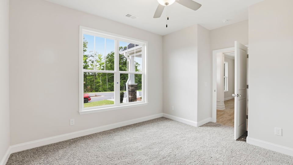 Bedroom with carpet and window.