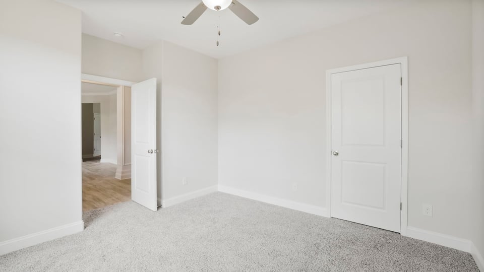 Bedroom with carpet and window.