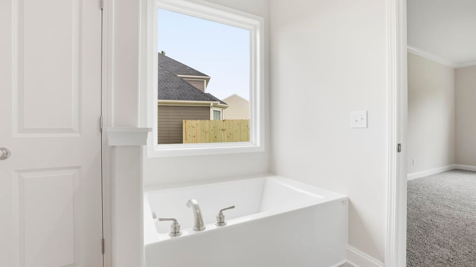 Bathroom with bathtub and window.