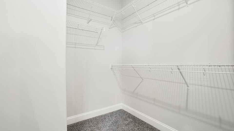 Closet with hanging storage racks.