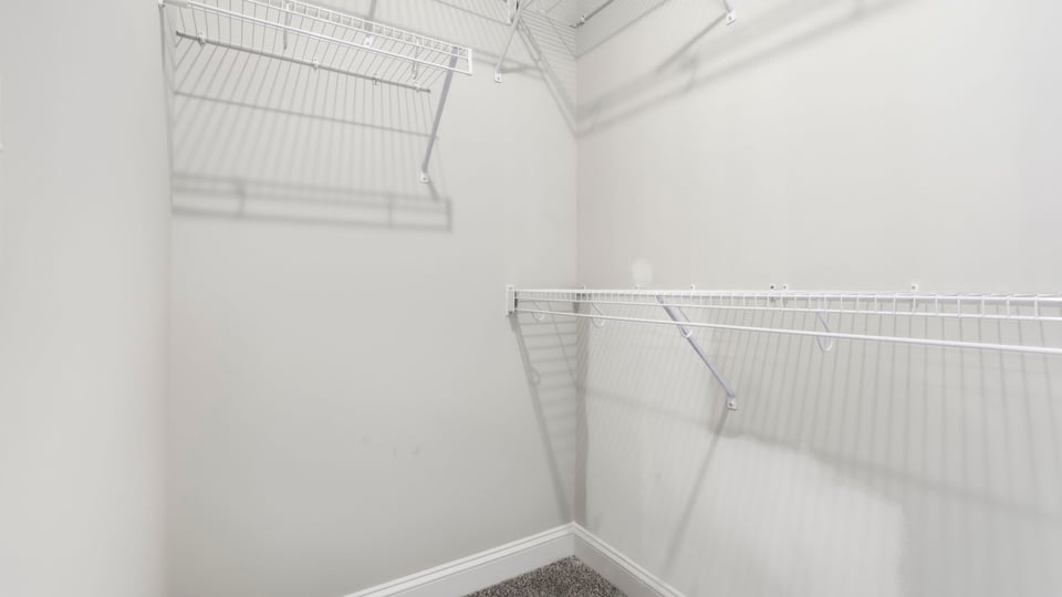 Closet with hanging storage racks.