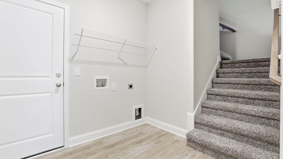 Laundry room with hanging storage racks.