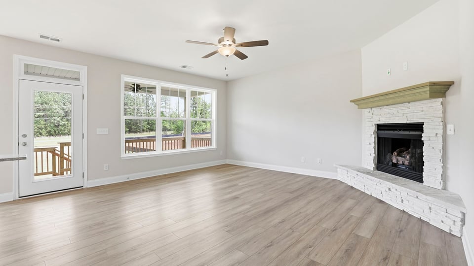 Family room with fireplace and windows.