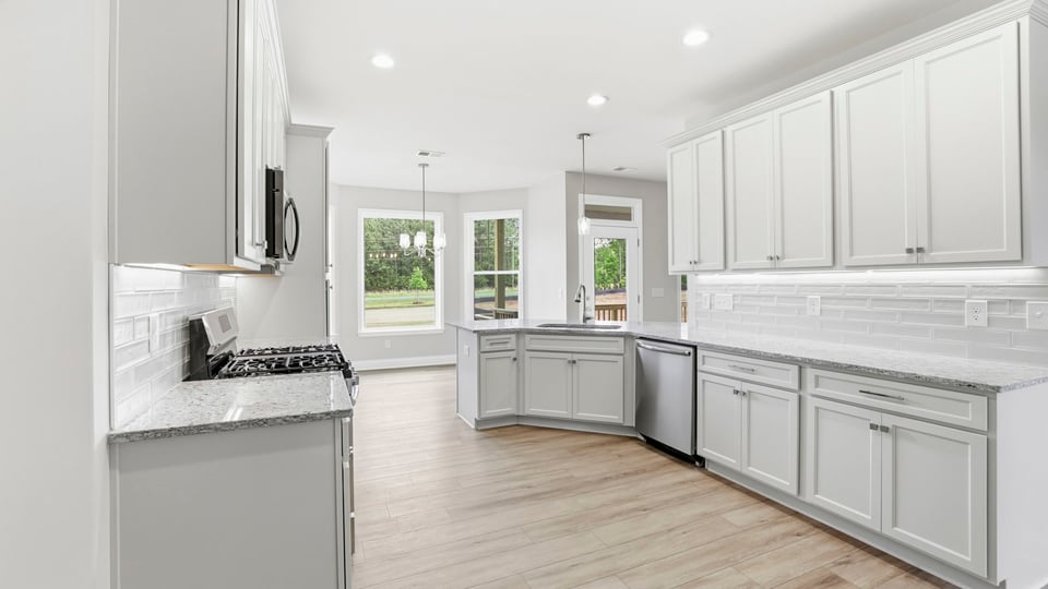 Kitchen and island with stainless steel appliances.
