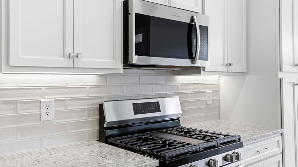 Kitchen and island with stainless steel appliances.