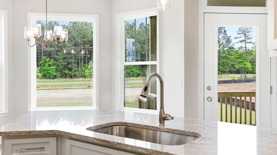 Kitchen and island with stainless steel appliances.