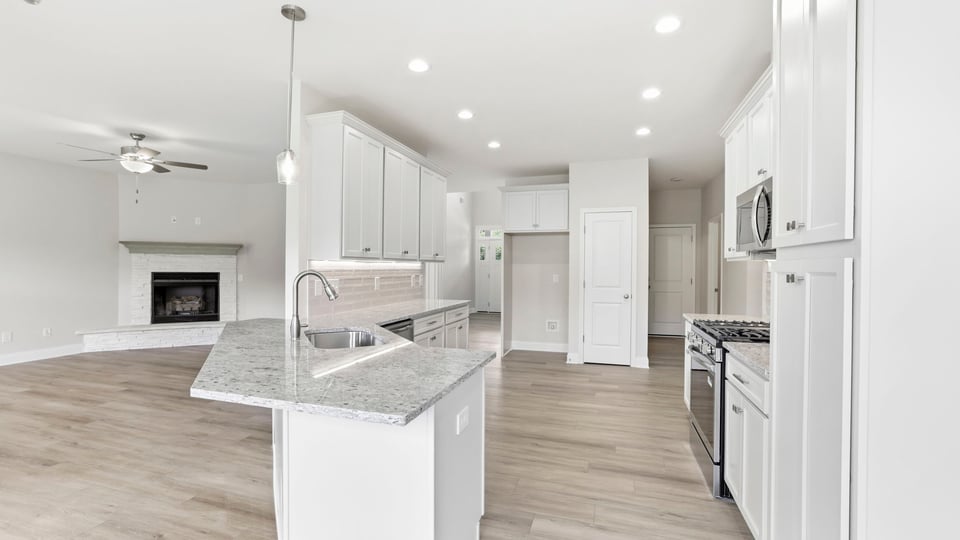 Kitchen and island with stainless steel appliances.