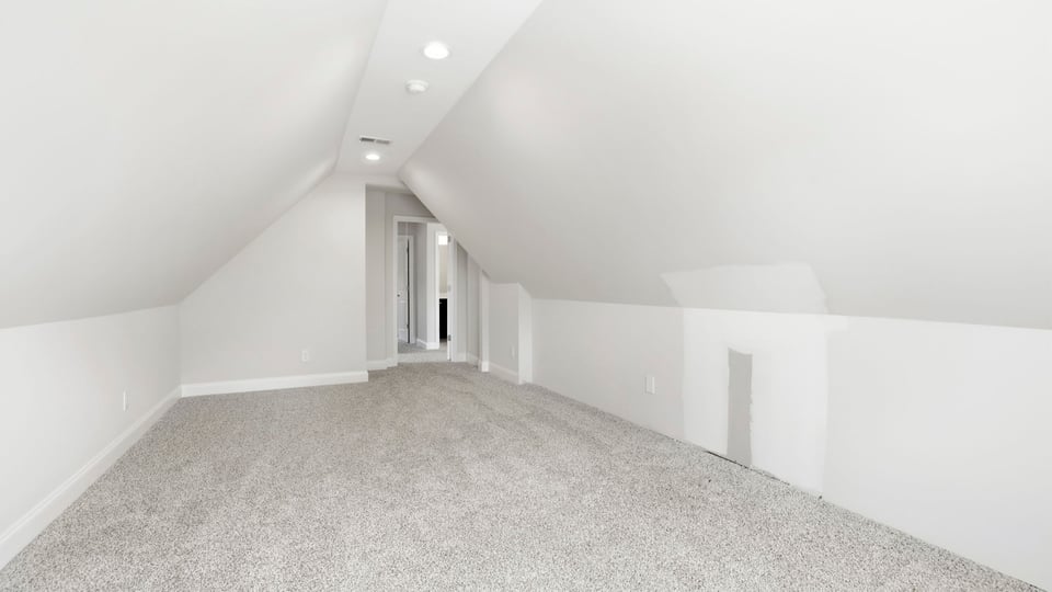 Bedroom with carpet and window.