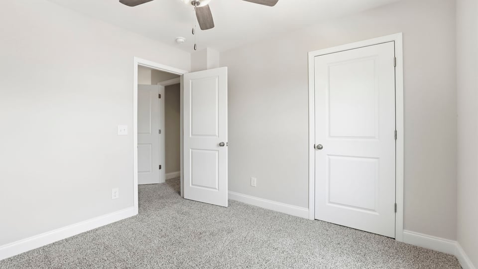 Bedroom with carpet and window.