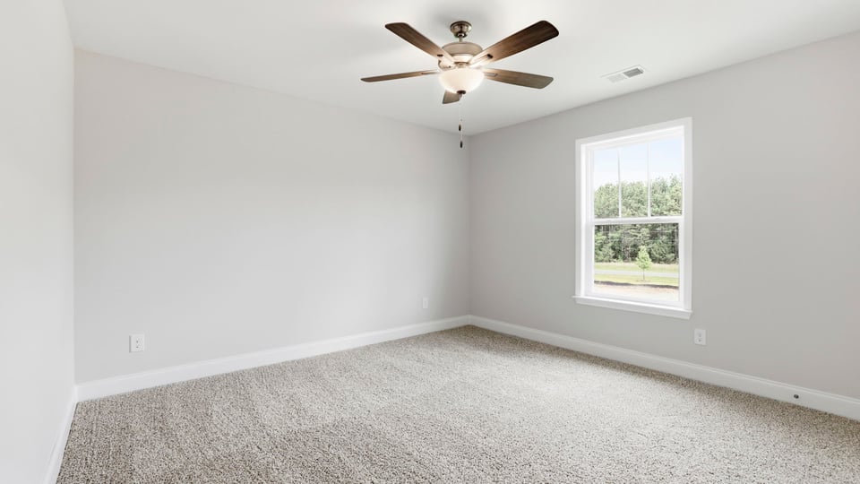 Bedroom with carpet and window.