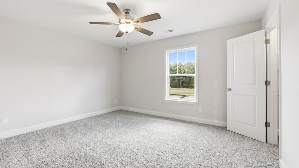 Bedroom with carpet and window.