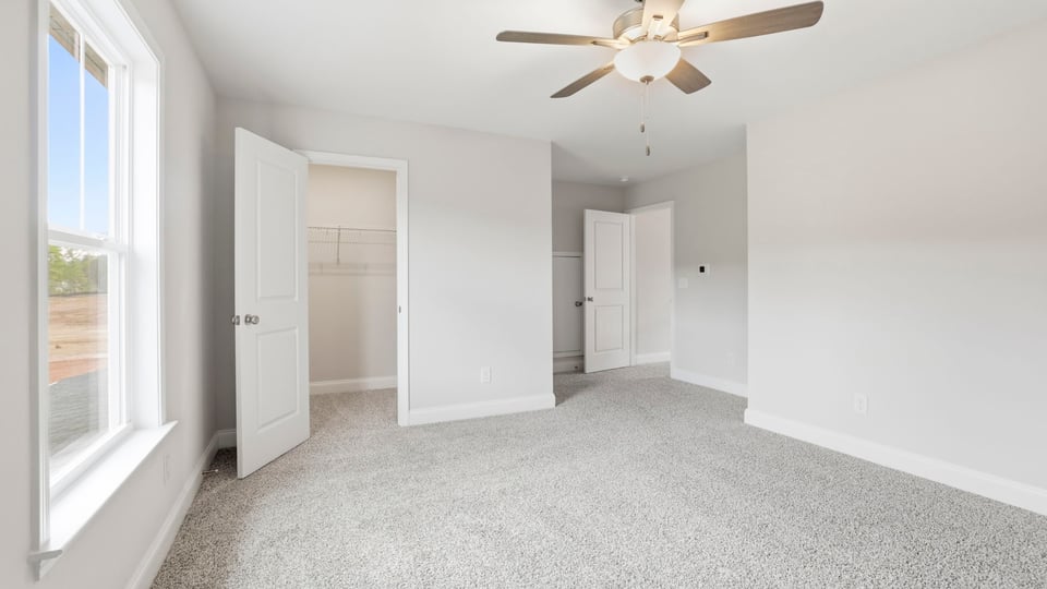 Bedroom with carpet and window.