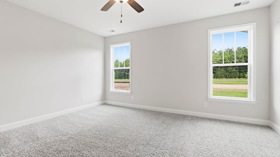 Bedroom with carpet and window.