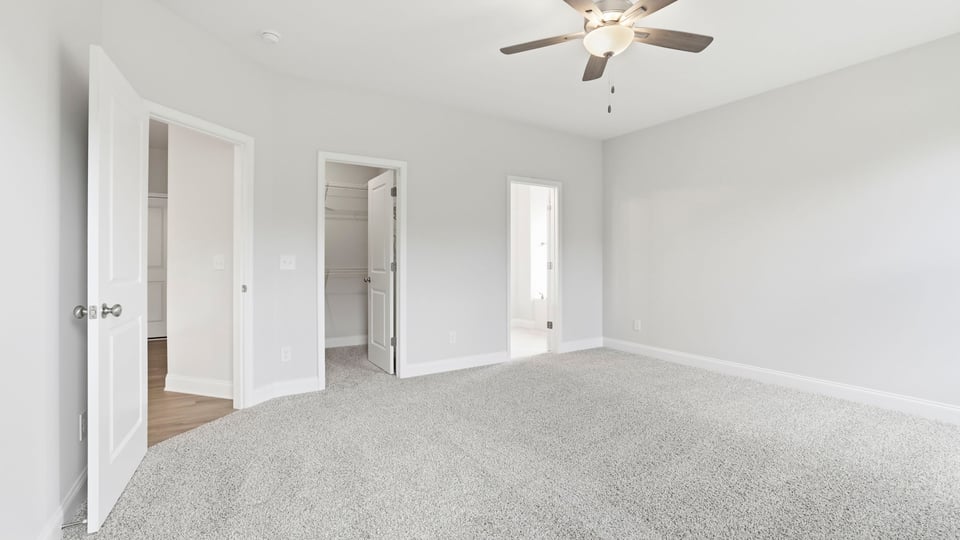 Bedroom with carpet and window.