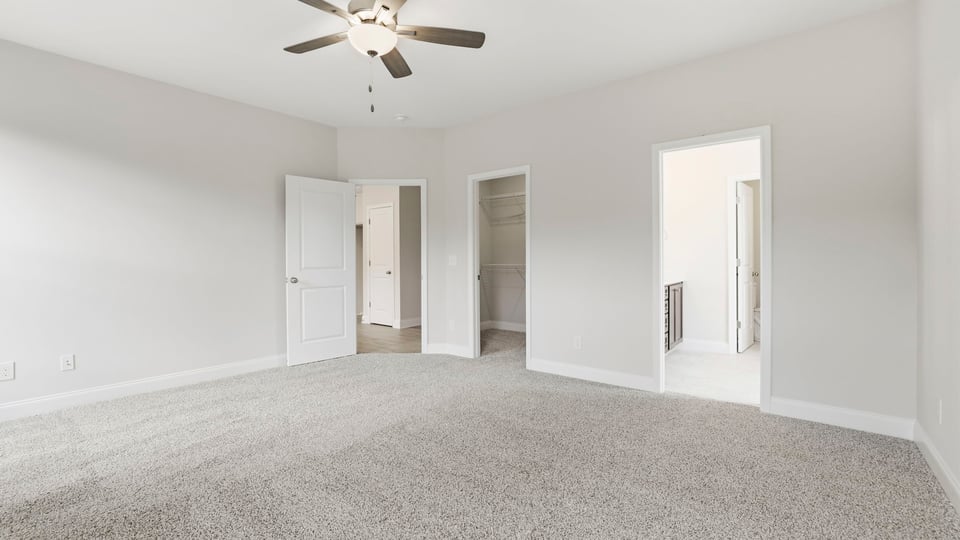 Bedroom with carpet and window.