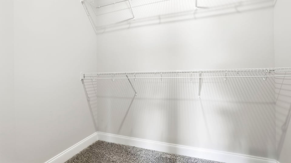 Closet with hanging storage racks.