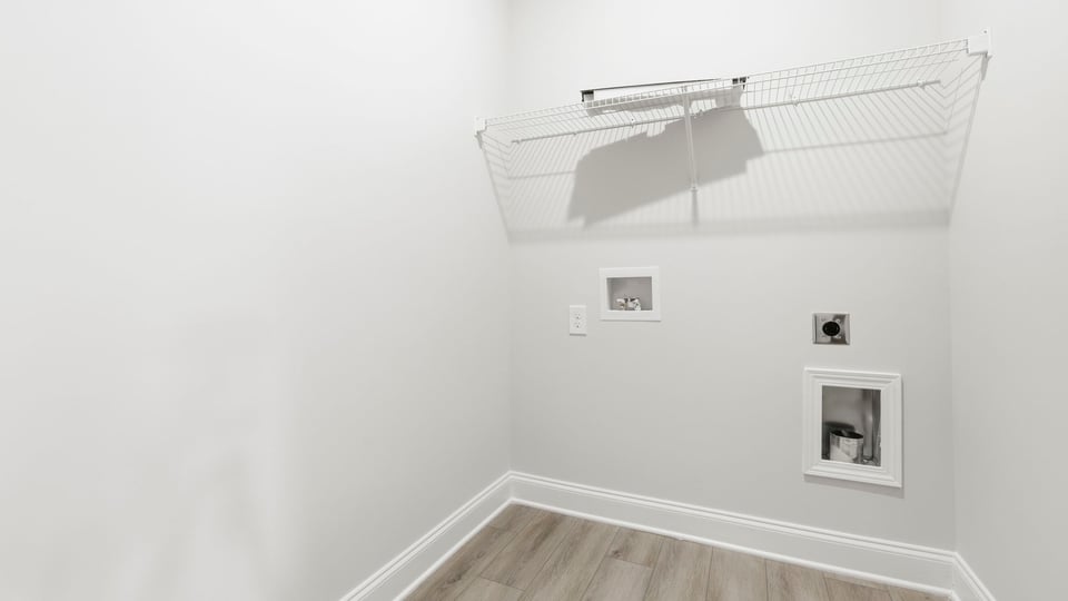 Laundry room with hanging storage racks.