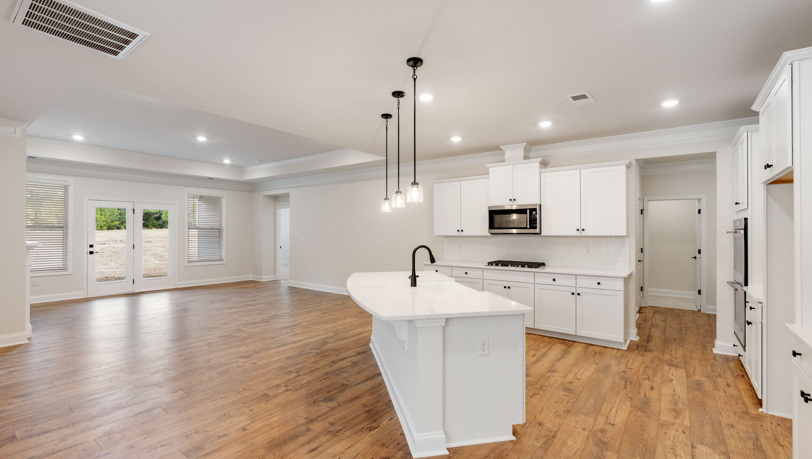 Kitchen and island with stainless steel appliances.