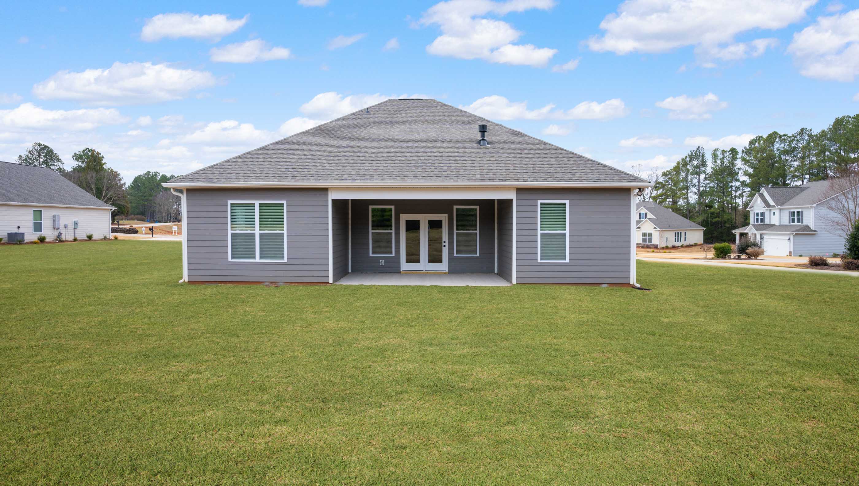 Back exterior of home with large backyard.