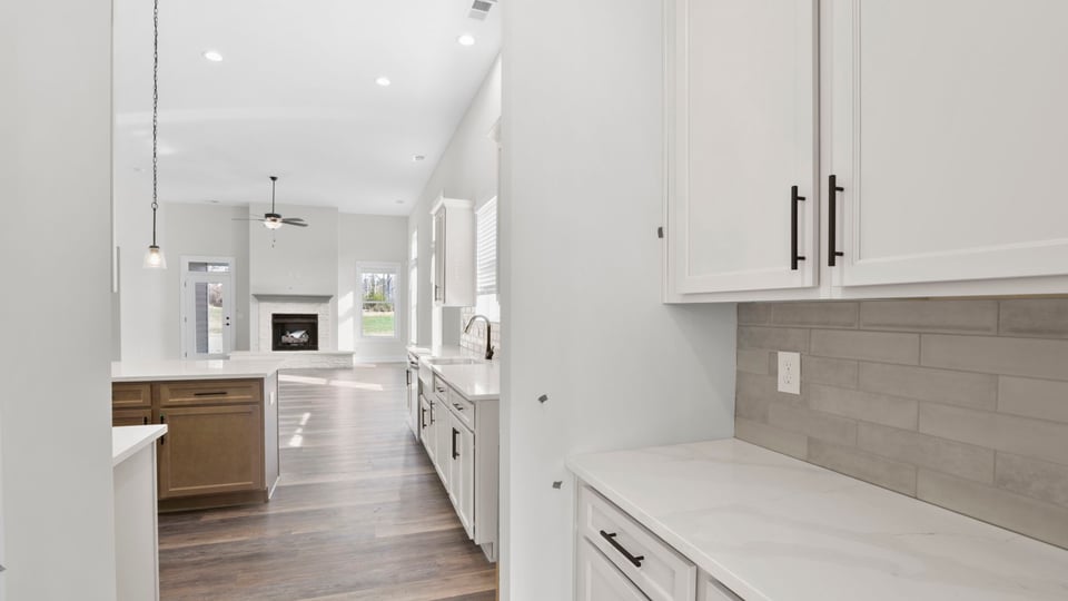Kitchen with quartz countertops and stainless steel appliances.