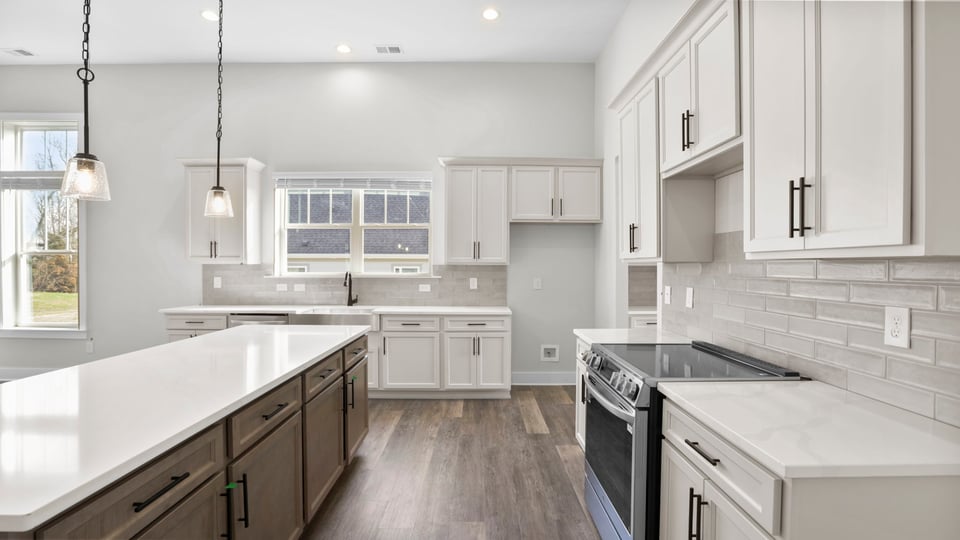 Kitchen with quartz countertops and stainless steel appliances.