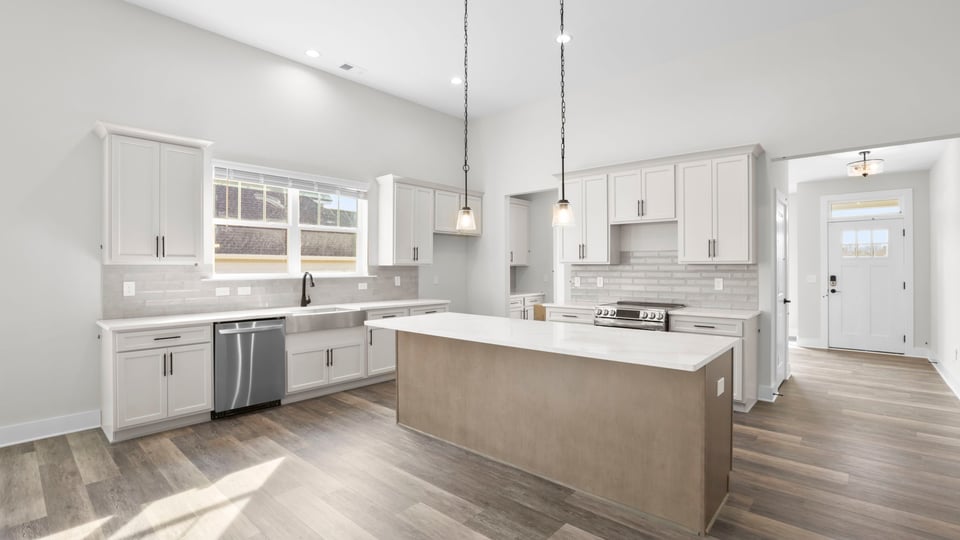 Kitchen with quartz countertops and stainless steel appliances.