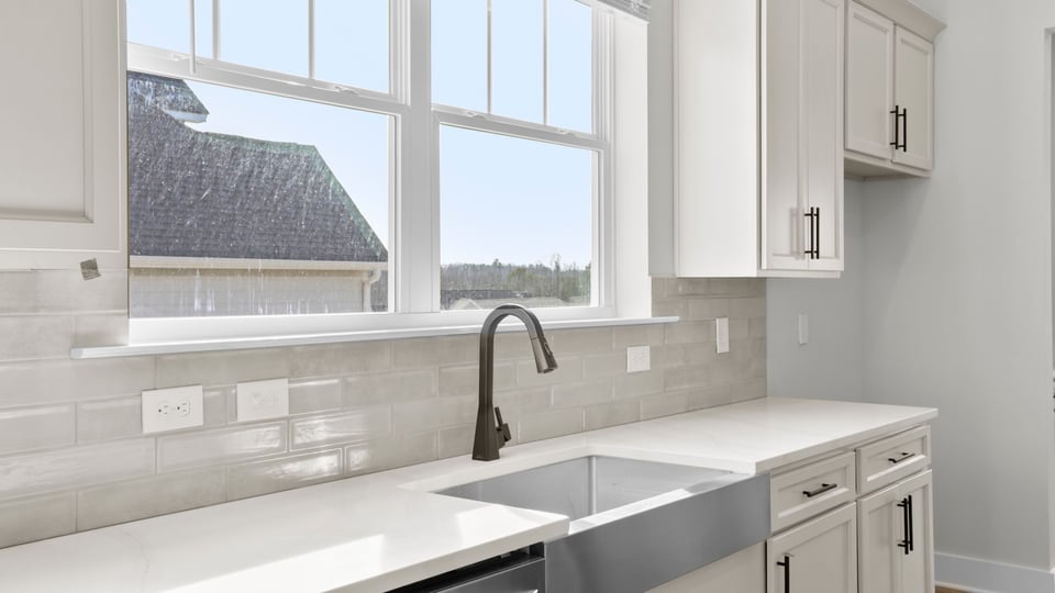 Kitchen with quartz countertops and stainless steel appliances.