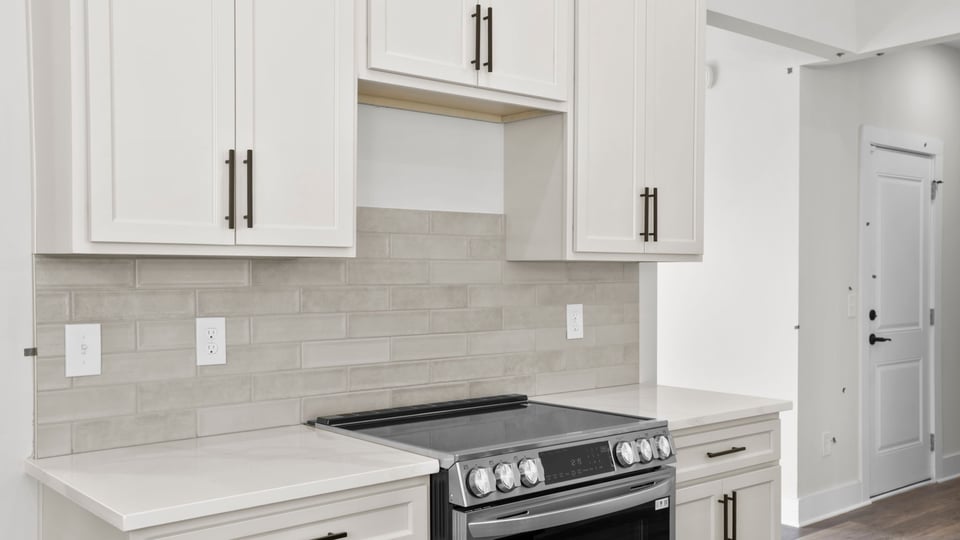 Kitchen with quartz countertops and stainless steel appliances.