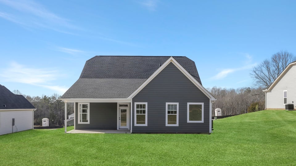 Back exterior of home with large backyard.