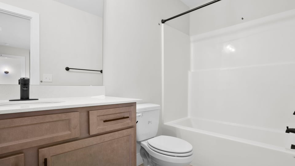 Bathroom with single vanity sink and tub.