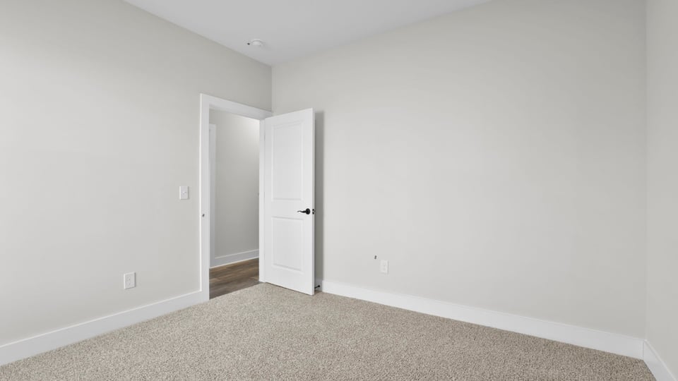 Bedroom with carpet and window.