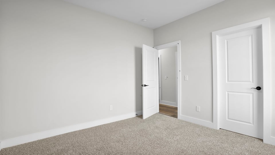 Bedroom with carpet and window.