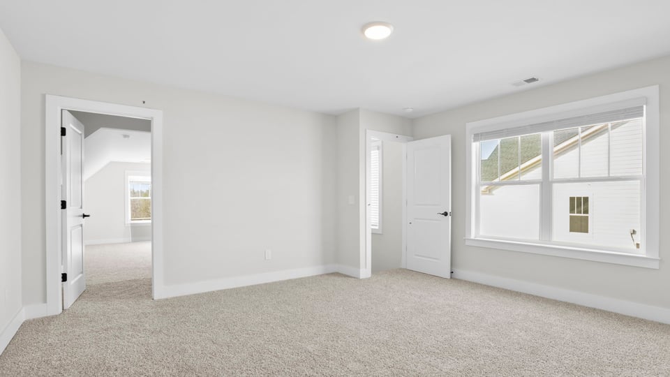 Bedroom with carpet and window.