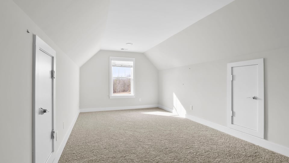 Bedroom with carpet and window.