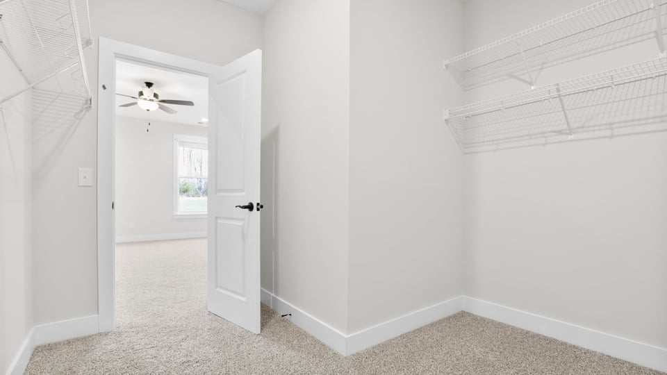 Closet with hanging storage racks.
