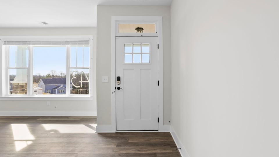 Hallway into home with view of front door.