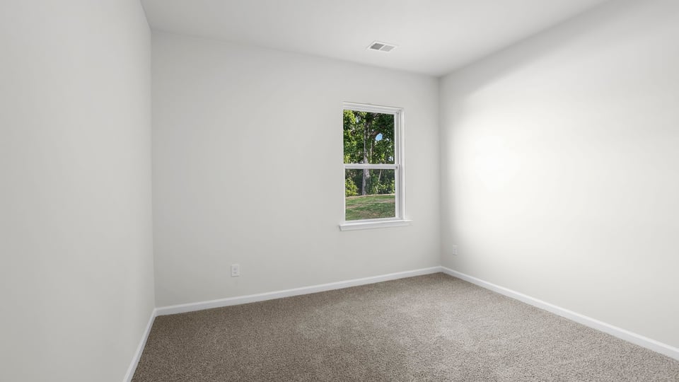 Bedroom with carpet and window.