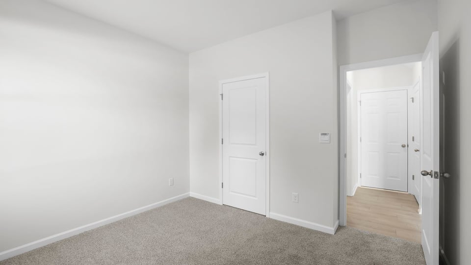 Bedroom with carpet and window.