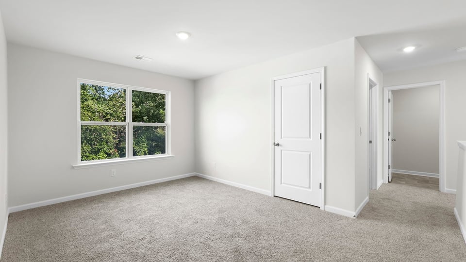 Bedroom with carpet and window.